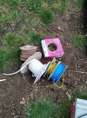 Lot 87 - Assorted pile of electrical wire on cardboard...